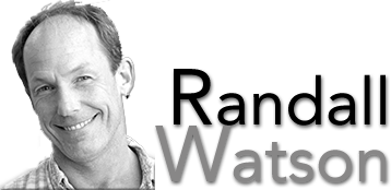 Black and white photo showing Randall Watson smiling with his head tilted as if inviting visitors to his website.